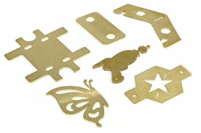 Laser cutting head profiling brass sheet metal Planet Industries