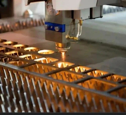 Laser cutting head cutting mild steel sheet metal sparks Planet Industries